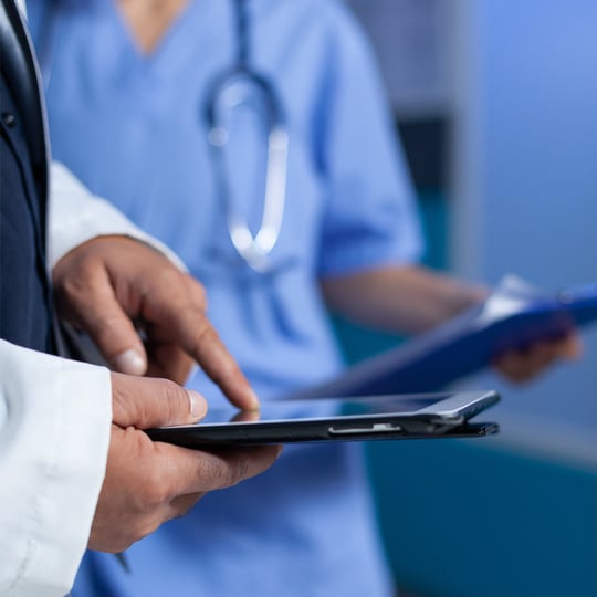 Close up of medic pointing at tablet screen for medical practice